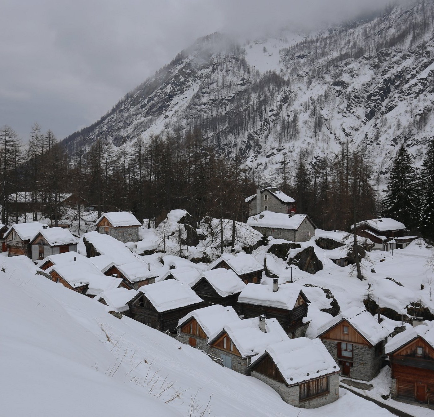 Bosco Gurin in Switzerland - a view of a snowy village in the mountains.
