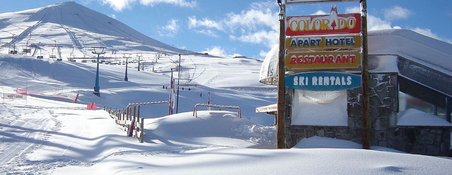 El Colorado | Farellones in Chile - a sign on the side of a snowy mountain.