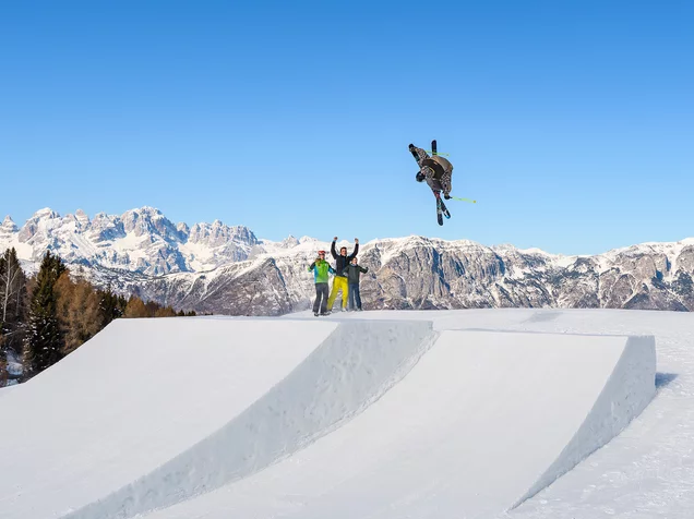 Monte Bondone in Italy - a snowboarder is doing a trick on a ramp.