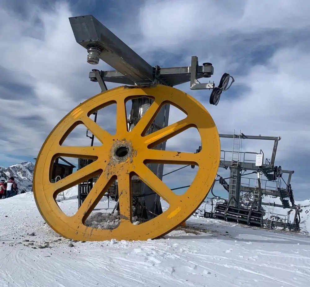 Astún in Spain - a large yellow machine sitting on top of snow covered ground.