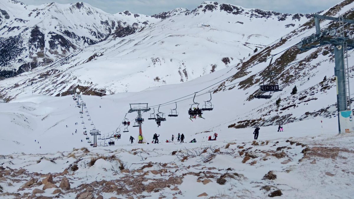 Astún in Spain - a ski lift going up a snowy mountain.
