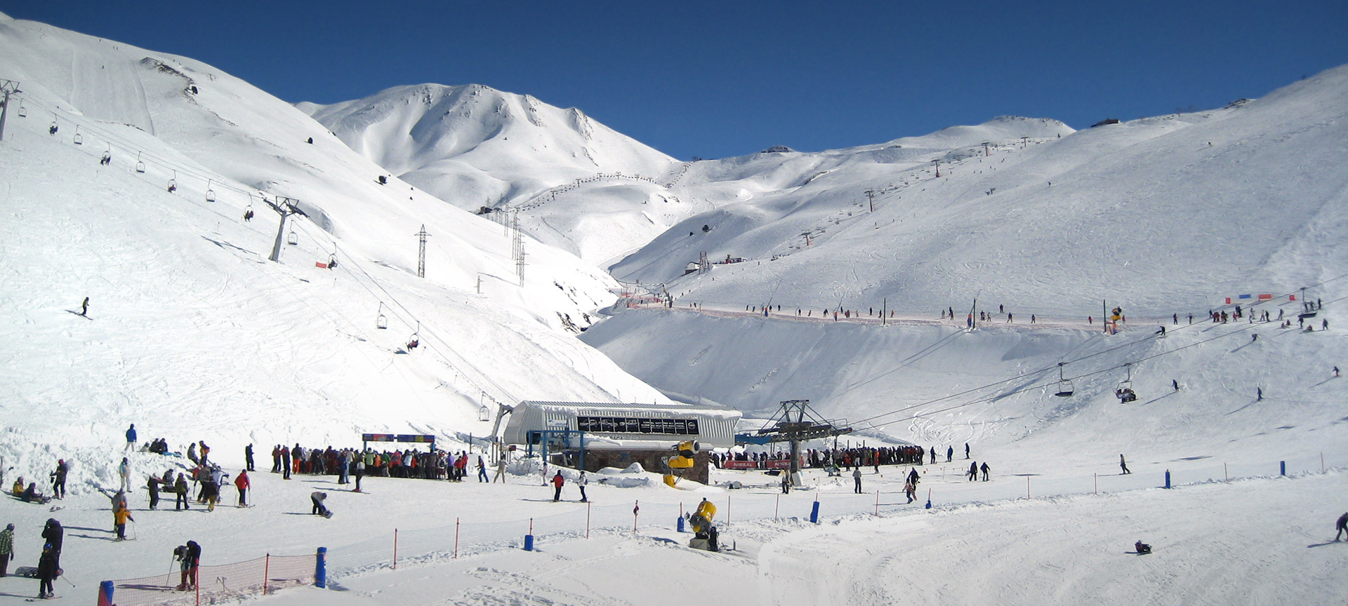 Astún in Spain - a group of people skiing down a mountain.