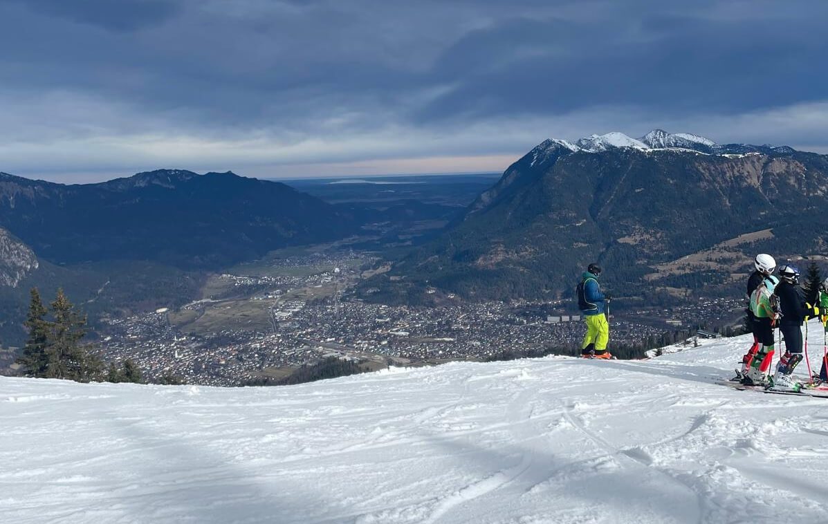Kolbensattel – Oberammergau in Germany - a group of people standing on top of a mountain.