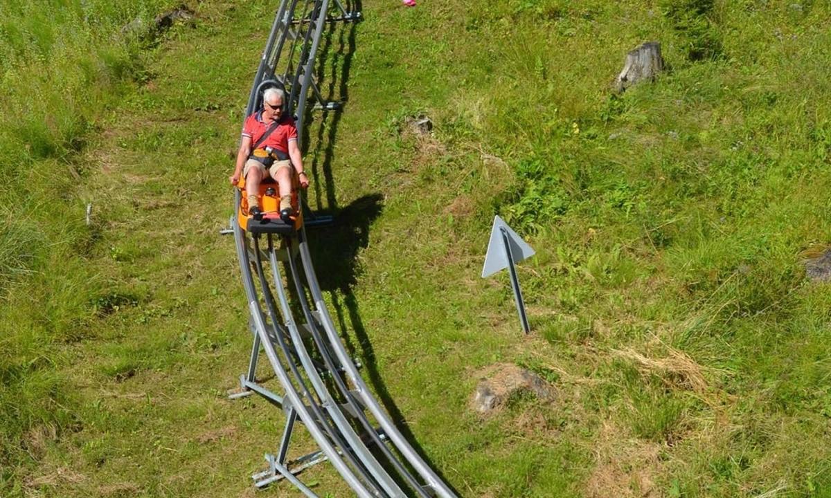 Kolbensattel – Oberammergau in Germany - a man riding on top of a train track.