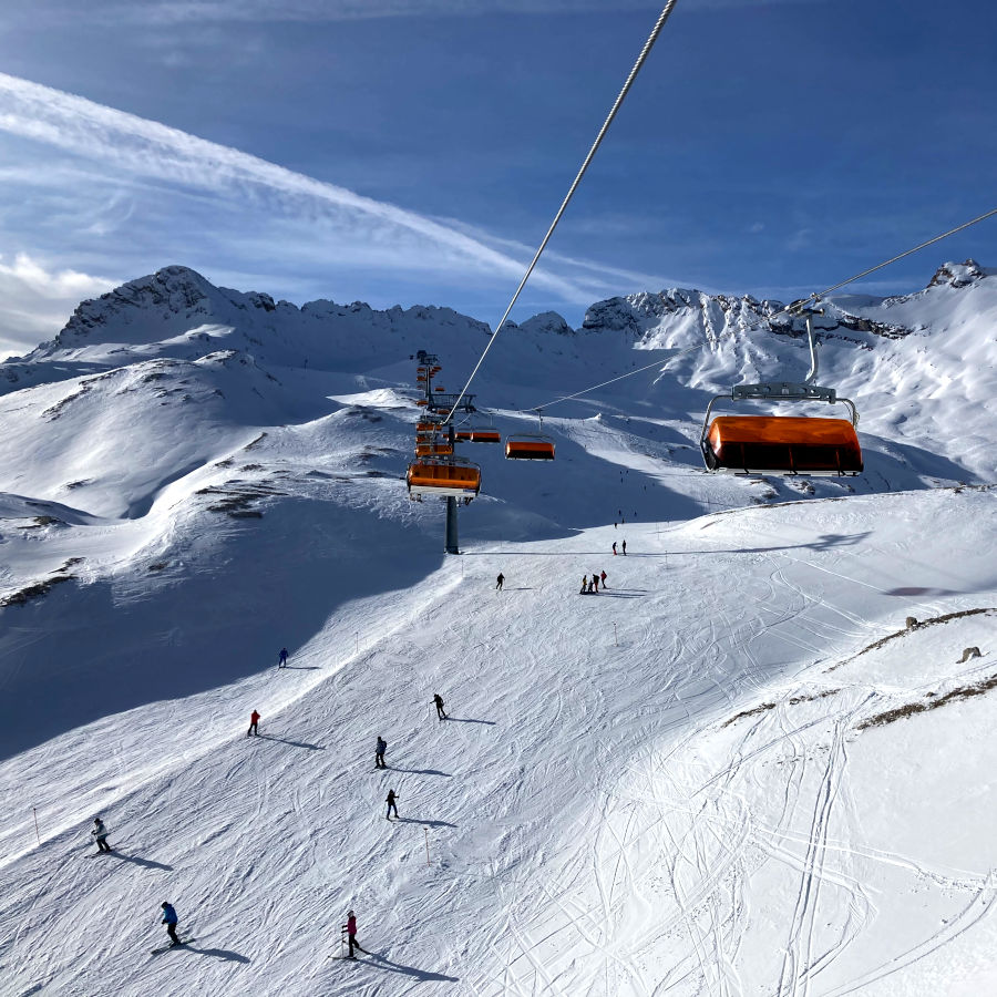 Kolbensattel – Oberammergau in Germany - a group of people skiing down a mountain.