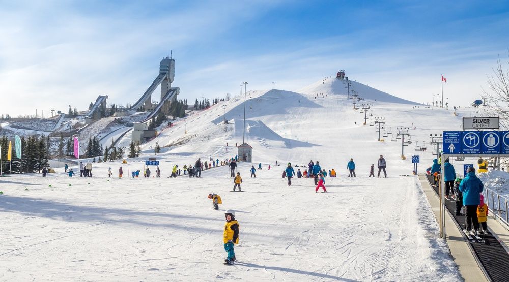 Canada Olympic Park – Calgary in Canada - a group of people skiing down a snow covered slope.