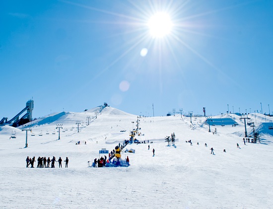 Canada Olympic Park – Calgary in Canada - a group of people skiing down a snow covered mountain.