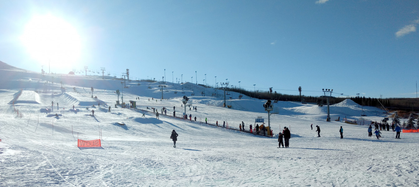Canada Olympic Park – Calgary in Canada - a group of people skiing down a snowy hill.