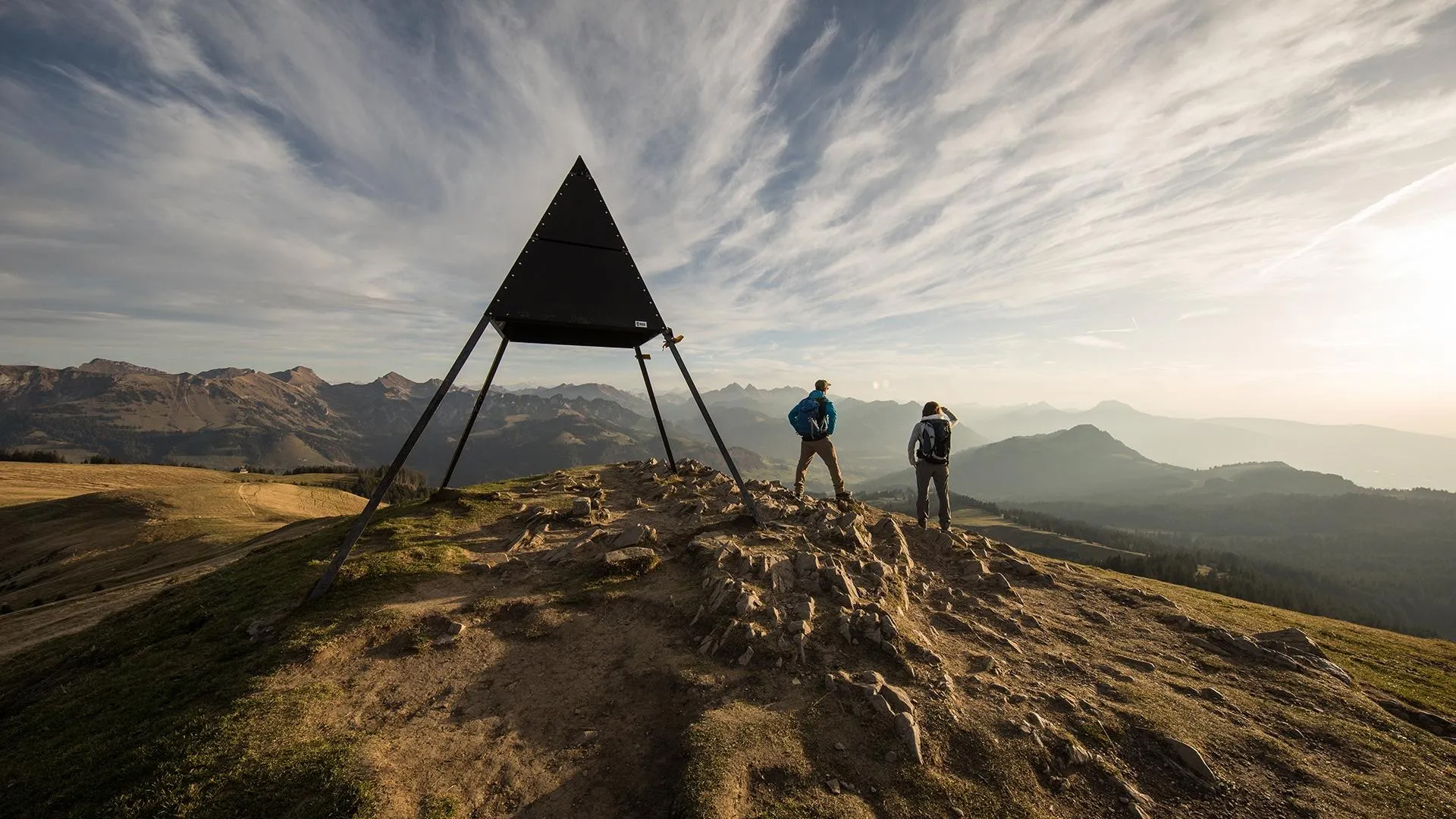 Overlooking a picturesque view of La Berra in Switzerland a charming chalet nestles amidst a mountainous landscape. Nearby a mountain bike hints at the adventures enjoyed in this beautiful setting.