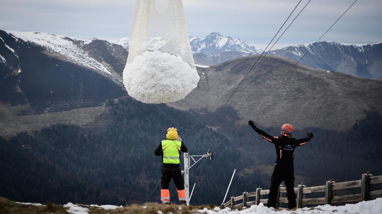 Luchon Superbagnères in France - two people standing on top of a snow covered mountain.