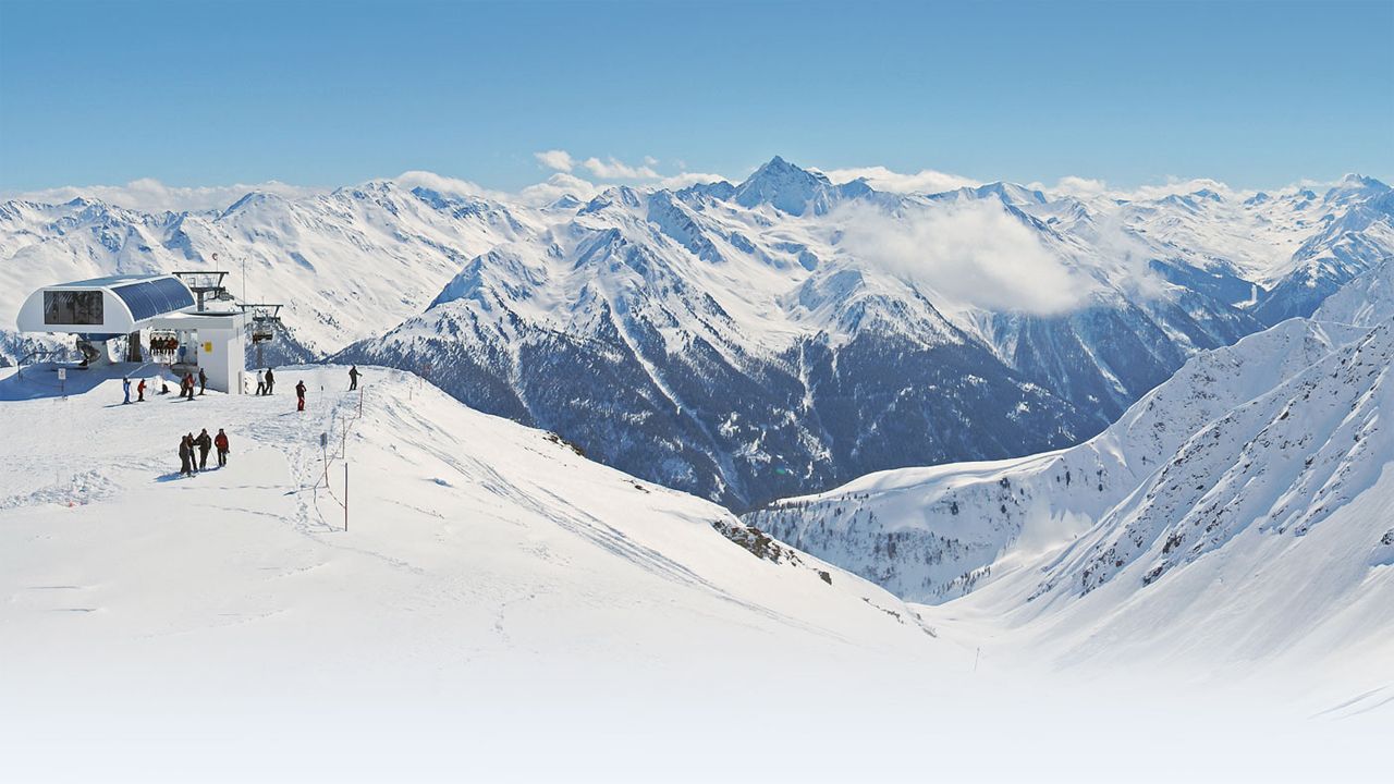 Kappl in Austria - a group of people standing on top of a snowy mountain.