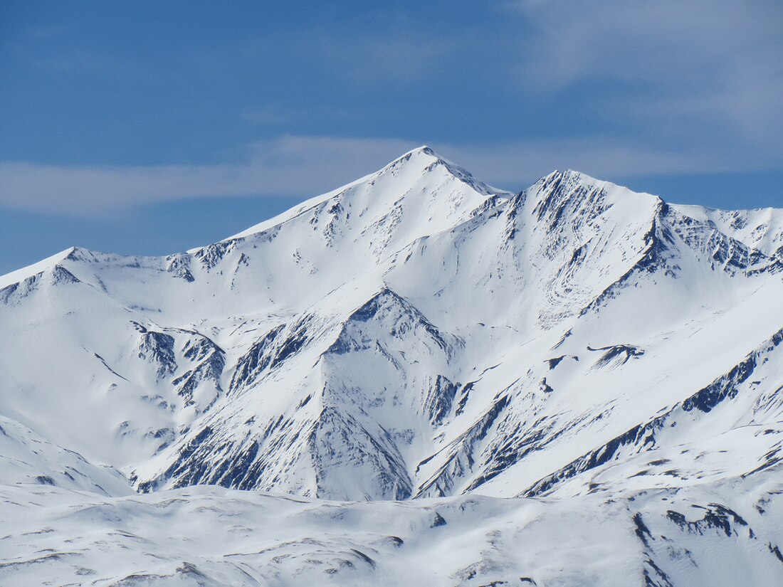 Tufandağ in Azerbaijan - a large mountain covered in snow under a blue sky.