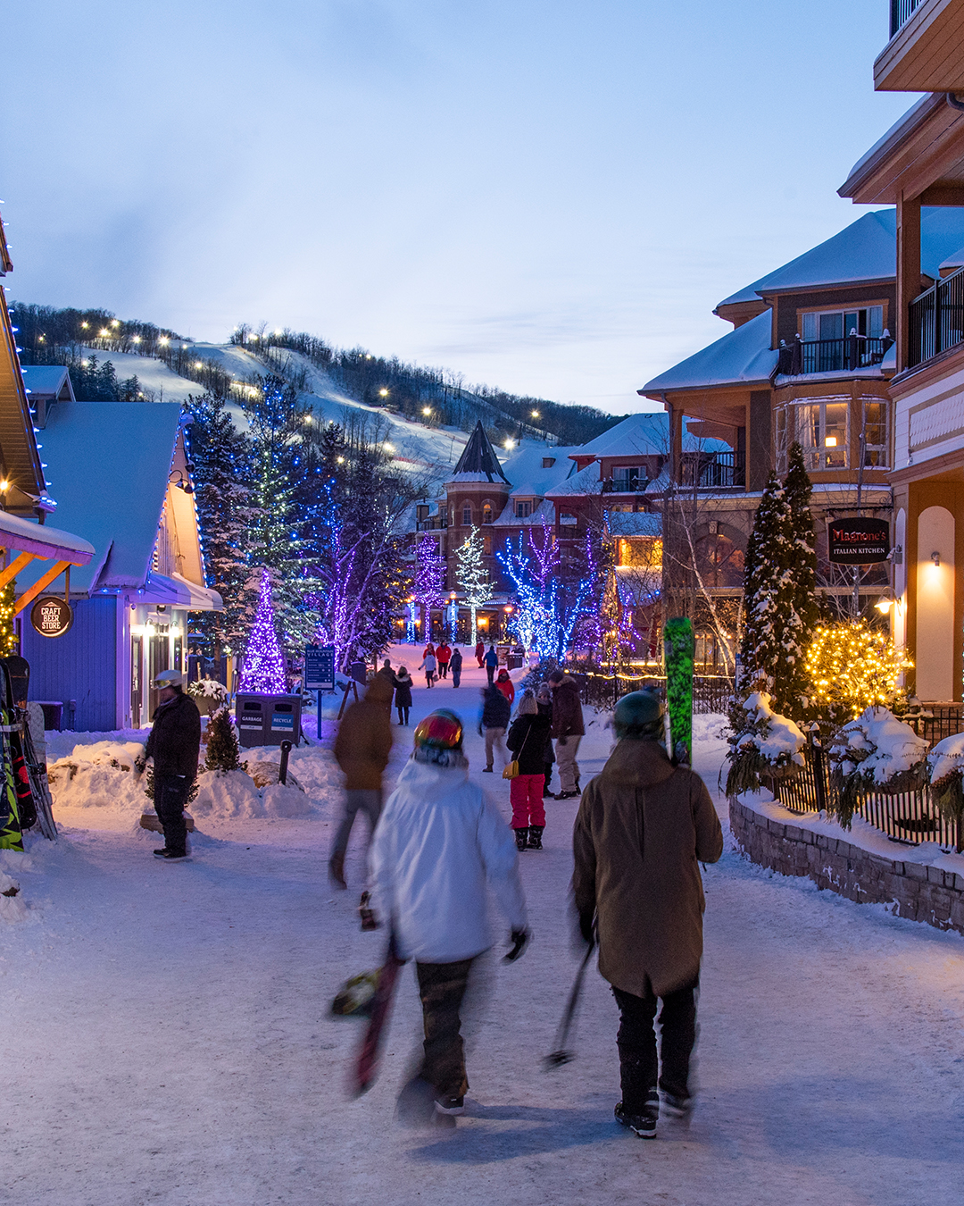 Blue Mountain Resort in Canada - a group of people walking down a snow covered street.