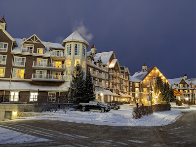 A winter vista at Blue Mountain Resort in Southern Ontario Canada featuring a bustling ski resort with a cozy lodge amid a beautifully serene snow-covered landscape perfect for winter sports enthusiasts.