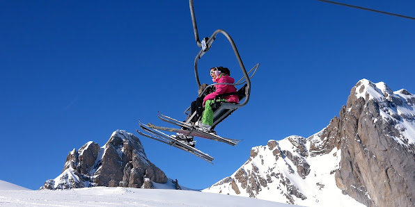 A skier enjoys the slopes at Station Gourette in Pyrénées-Atlantiques Nouvelle-Aquitaine France with a ski lift nearby. A picturesque winter sports scene at a ski resort.