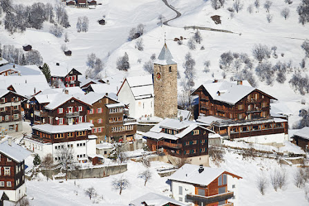 Ski resort in Tschiertschen, Switzerland, featuring a winter sports scene with a charming chalet amidst breathtaking winter scenery.