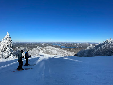 Winter sports scene at Bergbahnen Tschiertschen ski resort in Switzerland, featuring a skier on the white snowy slopes against the backdrop of majestic mountains.