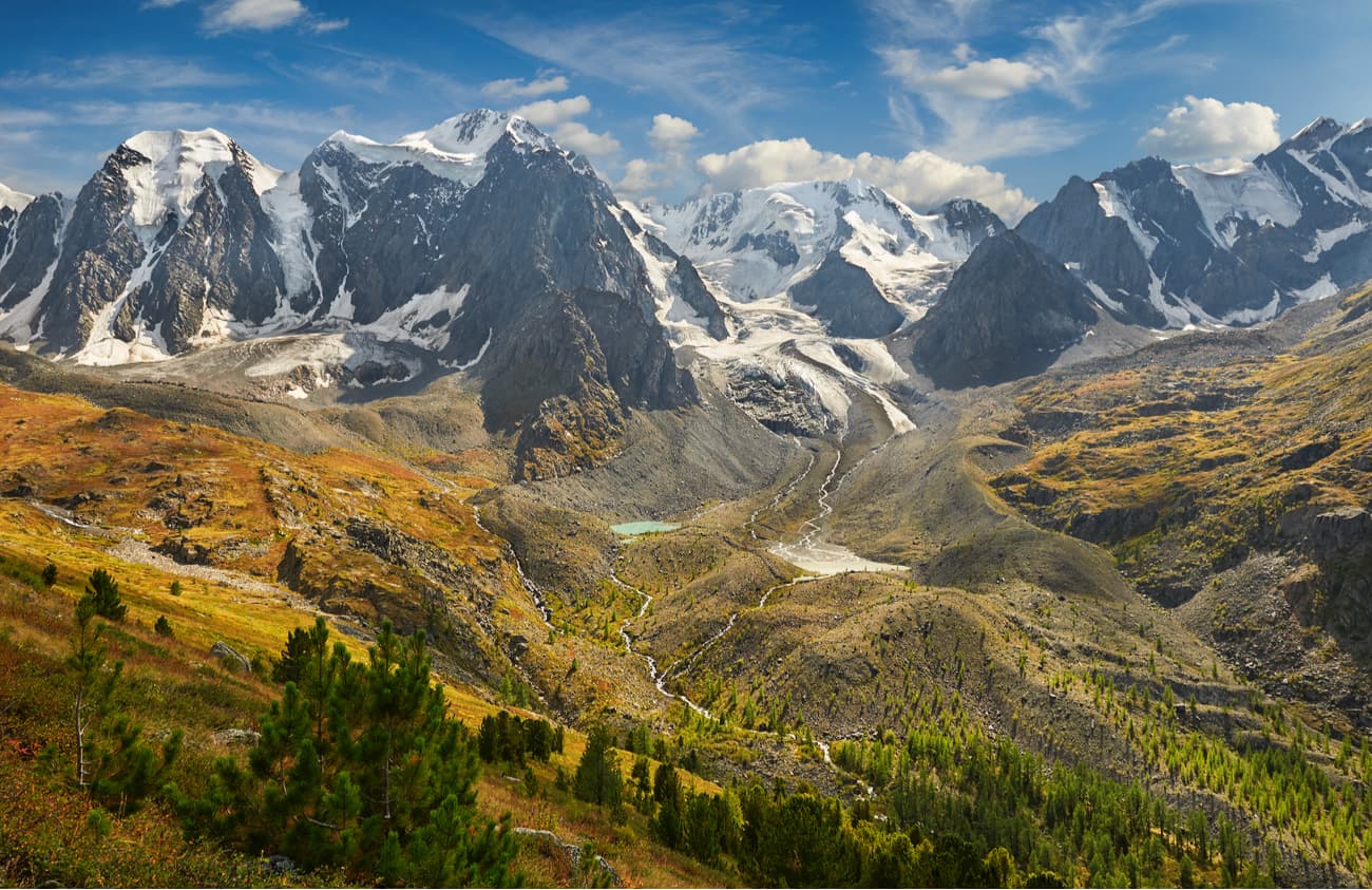 Manzherok in Russia - a mountain range with snow capped mountains in the background.