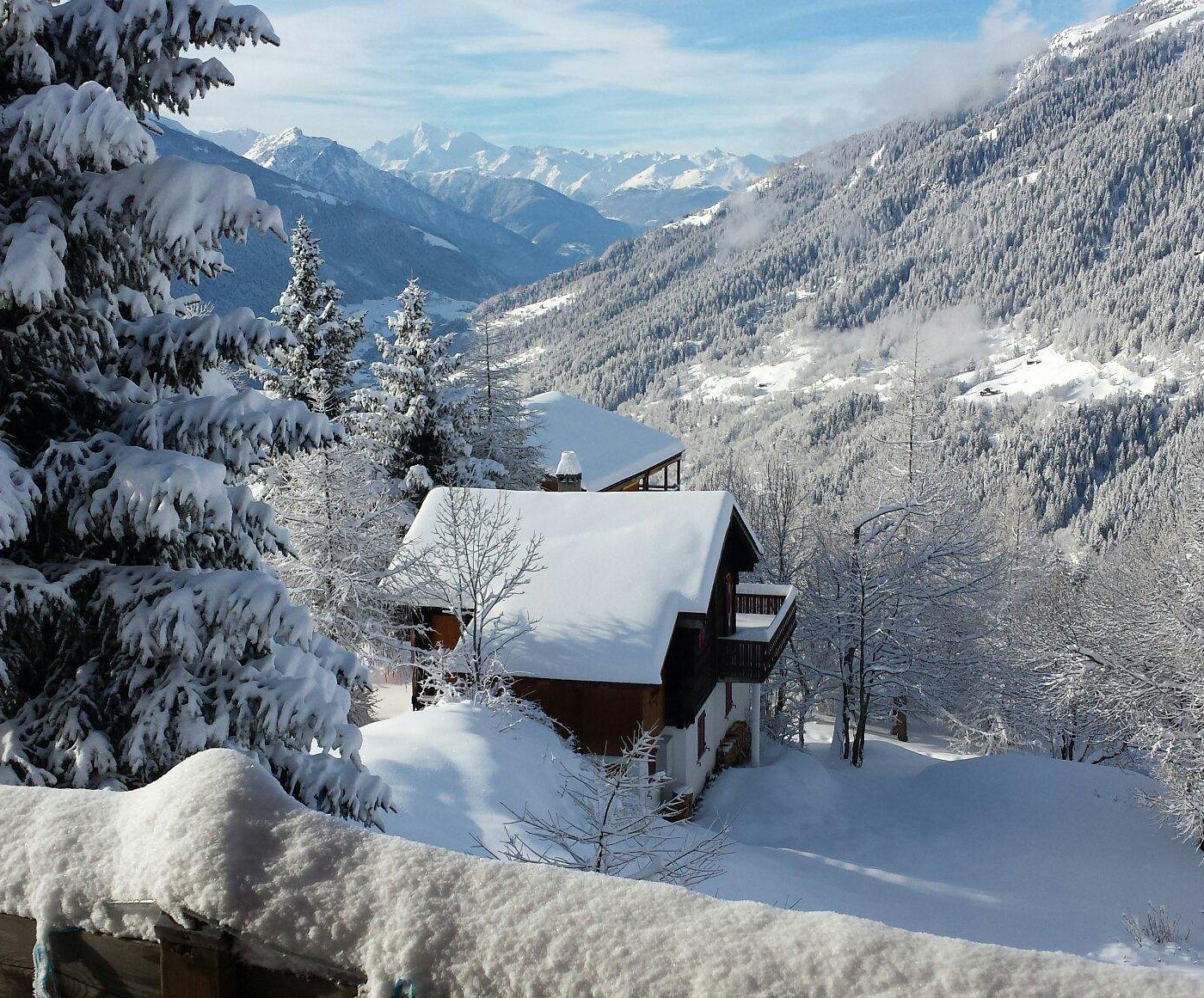 Bellwald in Switzerland - a house in the snow with mountains in the background.