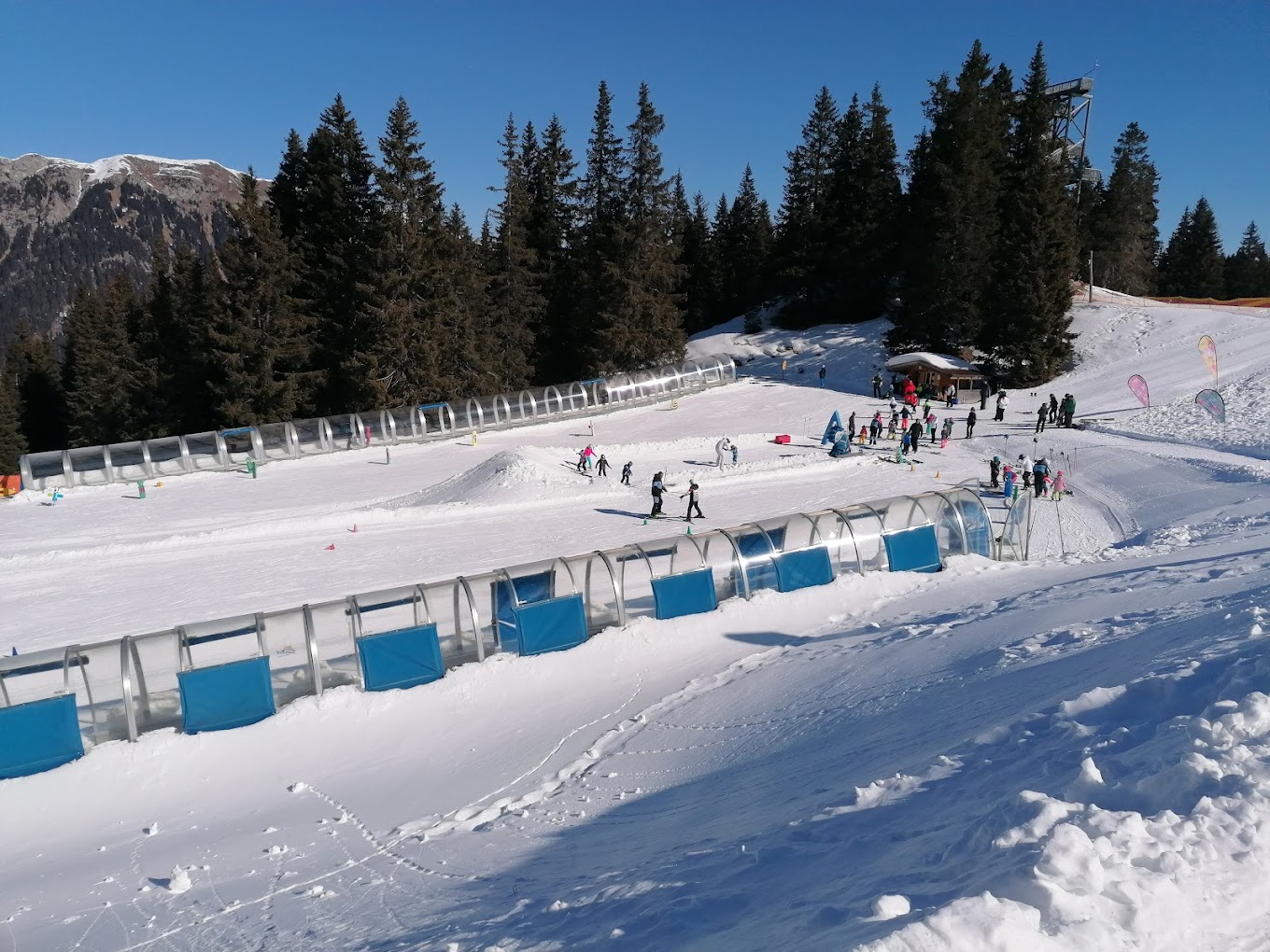 Racines-Giovo in Italy - a group of people skiing down a snow covered slope.