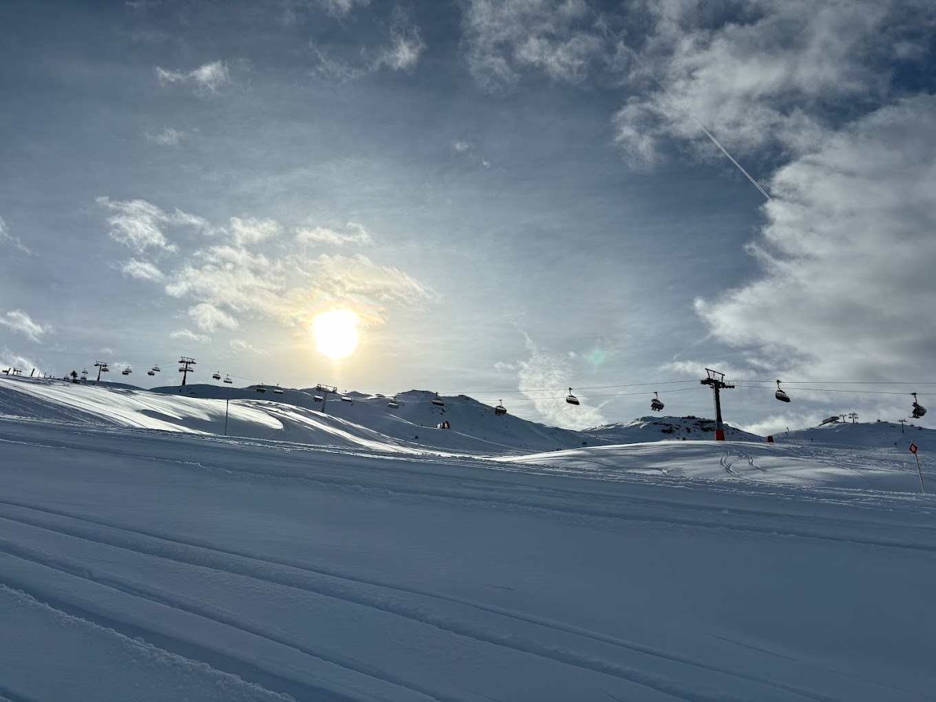 Racines-Giovo in Italy - the sun is shining in the sky above a ski slope.