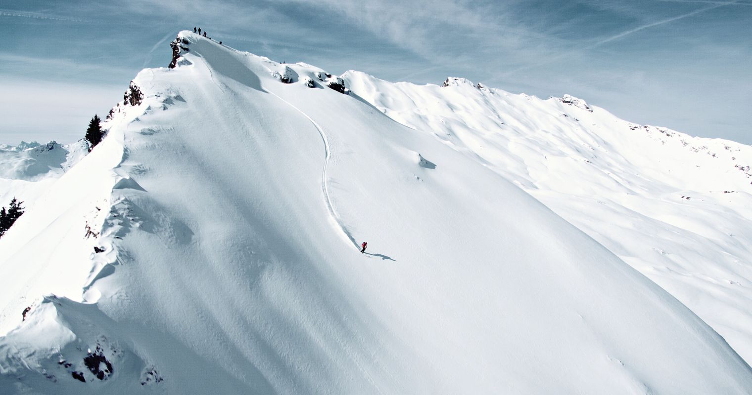 Wasserngrat Bergbahnen in Switzerland - a person on a snowboard on a snowy mountain.