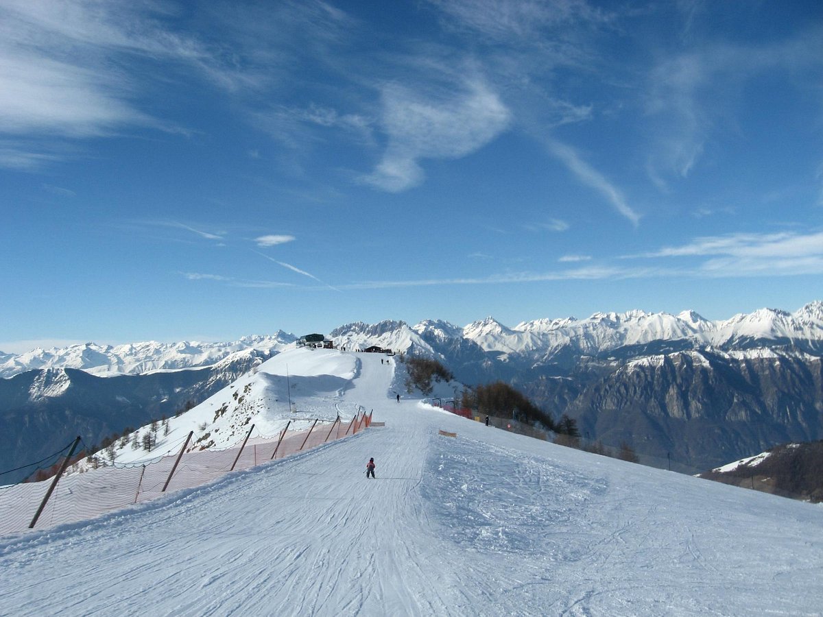 Montecampione Ski Area in Italy - a person skiing down a snow covered mountain.