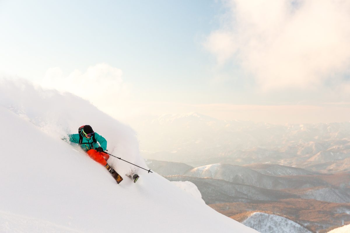 Alts Bandai - Hoshino Resorts Nekoma Mountain in Japan - a person skiing down a snow covered mountain.
