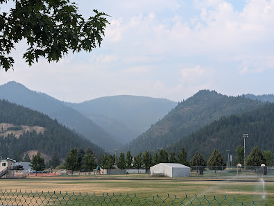 Snow-covered Silver Mountain in Kellogg Idaho with a charming chalet nestled amidst the slopes. The winter sports center of the ski resort is teeming with activity blending in with the idyllic winter sports scene.