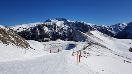 A ski resort at Silver Mountain in Kellogg Idaho featuring a chalet with skiers engaging in winter sports on the snow-covered slopes.