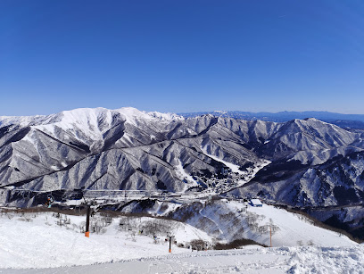 Winter scenery at Straja ski resort in Romania, displaying snow-covered slopes and winter sports activities under a breathtaking cloudy sky.