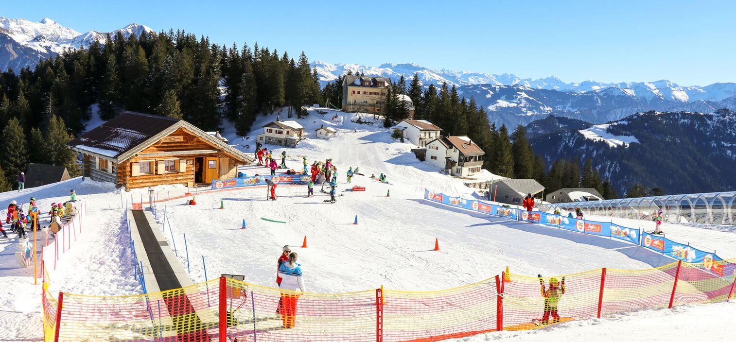 Pizol Pardiel Bad Ragaz Wangs in Switzerland - a group of people skiing down a snow covered slope.