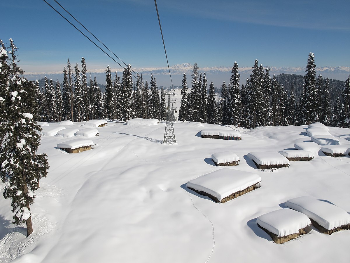 Pahalgam in India - a ski lift going up a snowy mountain.