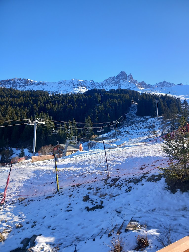 Méribel in France - a snow covered ski slope with a ski lift in the background.