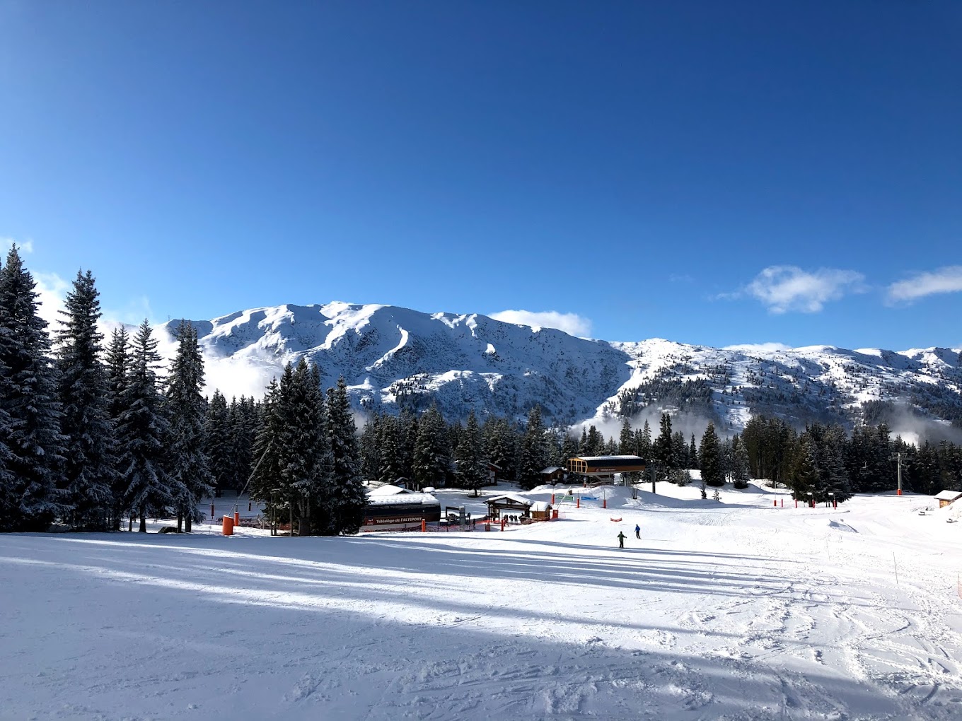 Méribel in France - a snow covered ski slope with trees in the background.