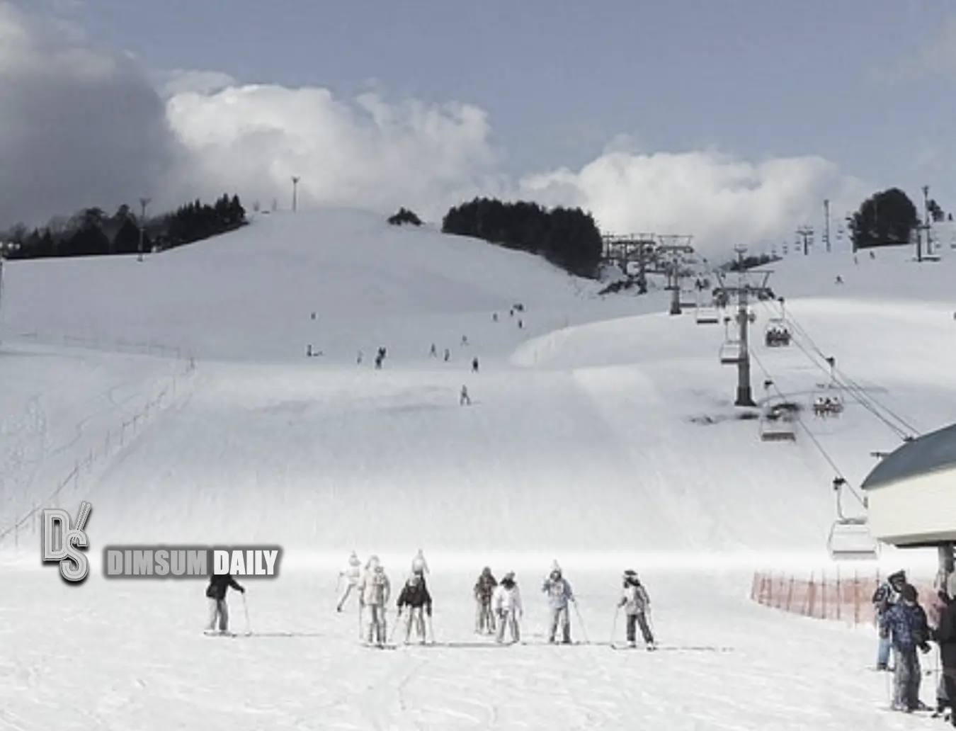 HachiKita Highlands in Japan - a group of people skiing down a snowy hill.
