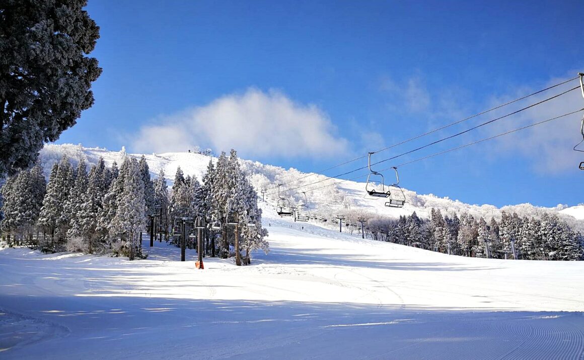 HachiKita Highlands in Japan - a ski lift going up a snowy mountain greeting card.