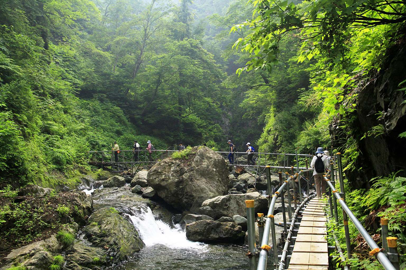 A quaint chalet nestled at the base of a mountain in Aomori Spring Tōhoku Honshu Japan bathed in the glow of a sunny day.