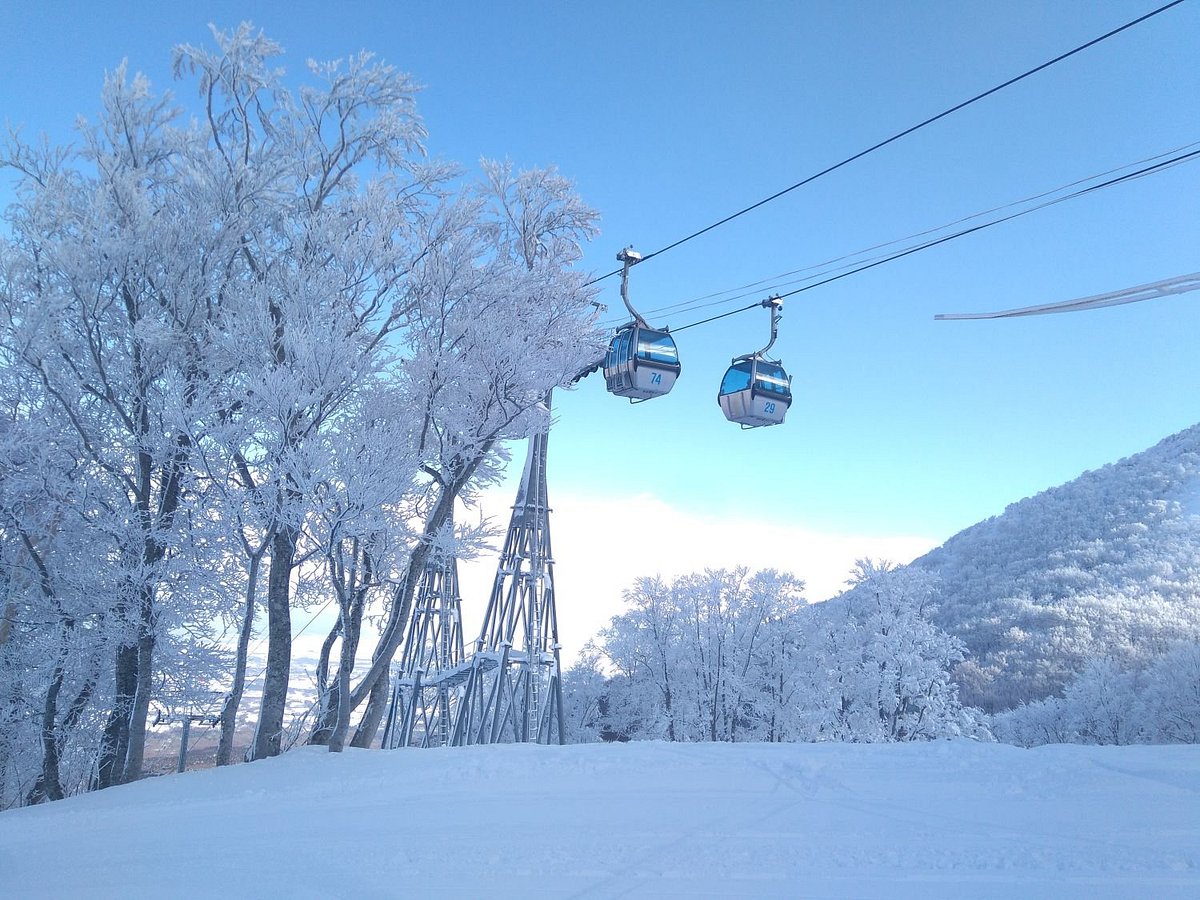 Aomori Spring in Japan - a ski lift going up a snowy hill.