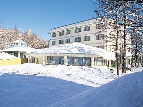 Winter scene at Hakuba 47 | Goryu ski resort in Chūbu, Japan featuring a stunning snowy landscape and a charming chalet amidst the winter sports centre.