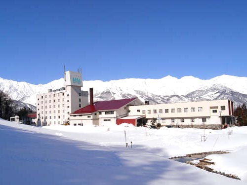 View of Hakuba 47 in Honshu, Japan featuring a well-equipped winter sports centre, a picturesque ski resort, and a cozy chalet. The stunning winter scenery, blanketed in snow, completes the captivating view.