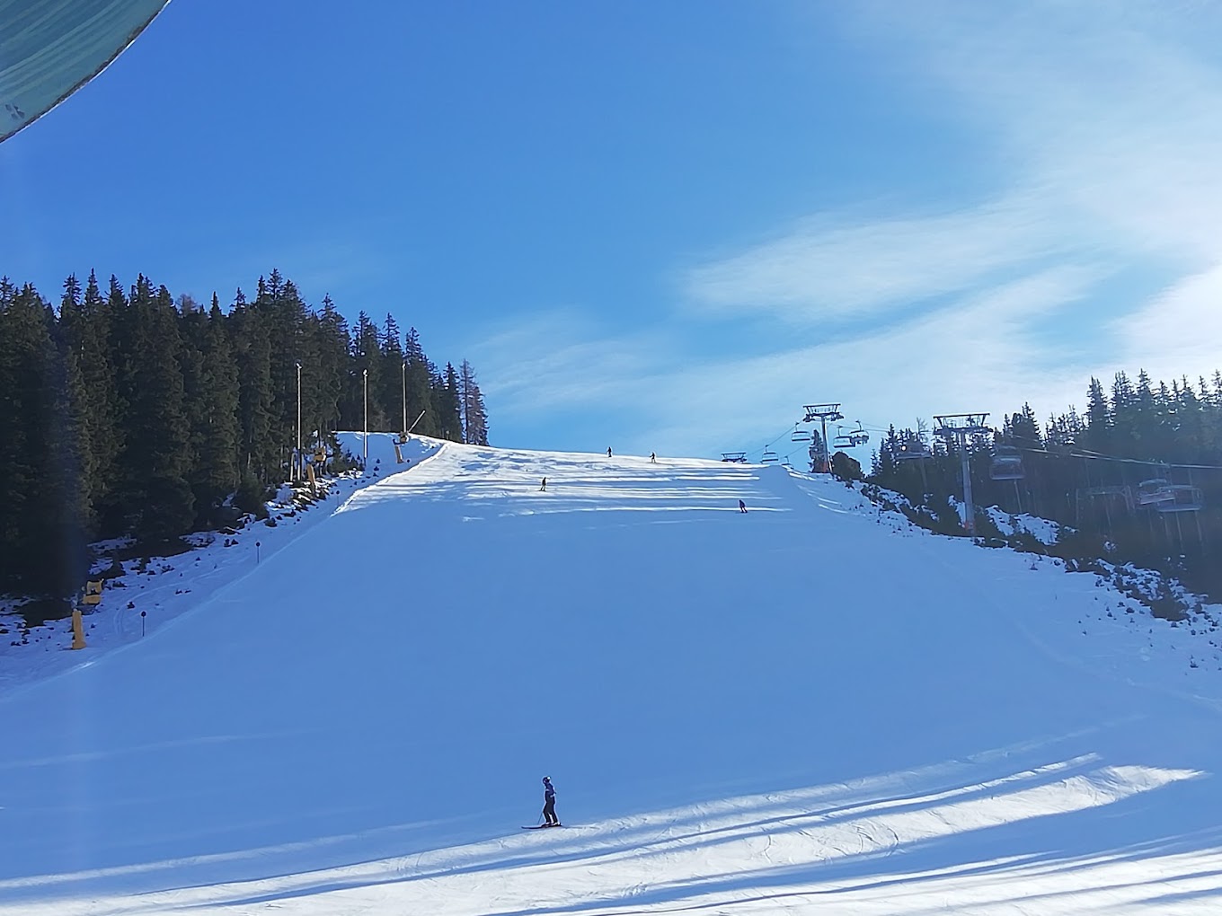 See in Austria - a person on a snowboard going down a hill.