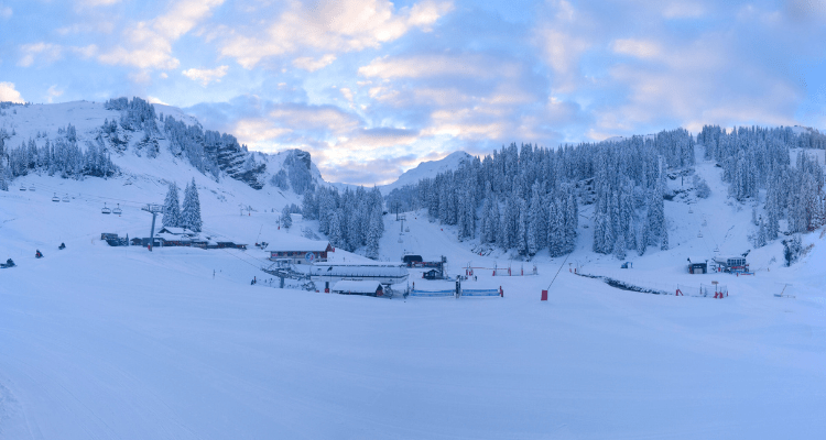 Avoriaz 1800 in France - a group of people skiing down a snow covered mountain.