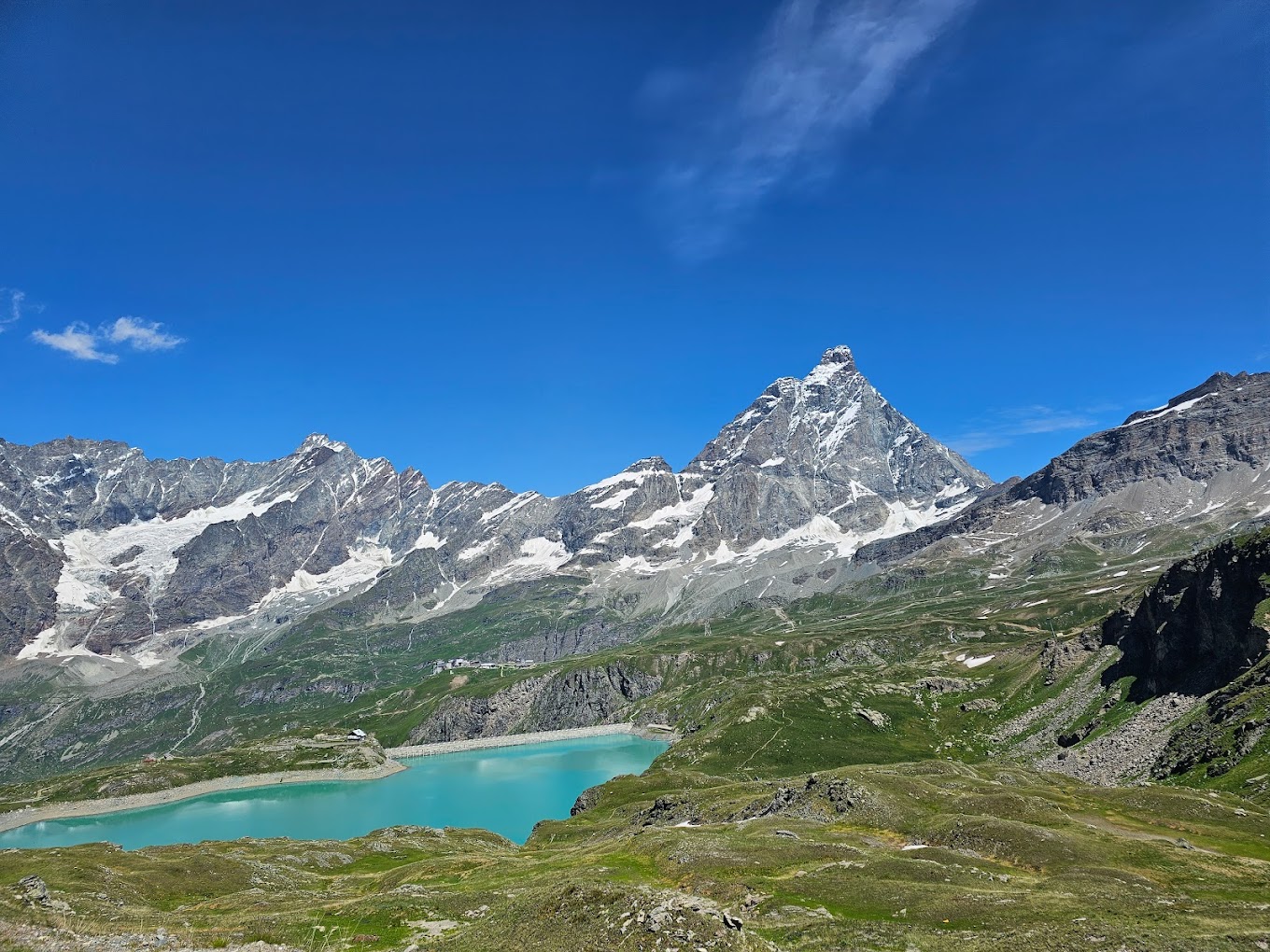 Cervinia Cielo Alto in Italy - the view from the top of a mountain with a lake in the fore.
