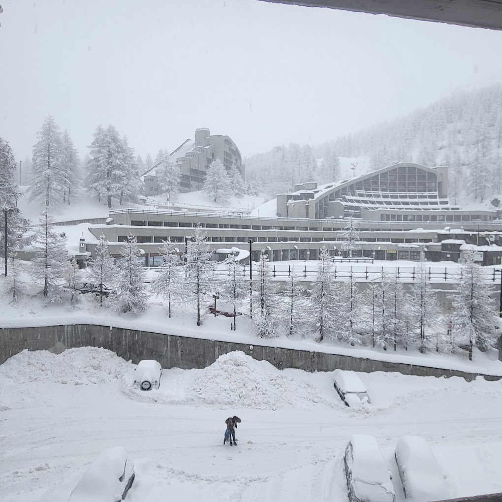Cervinia Cielo Alto in Italy: a view of a snow covered building from a window.