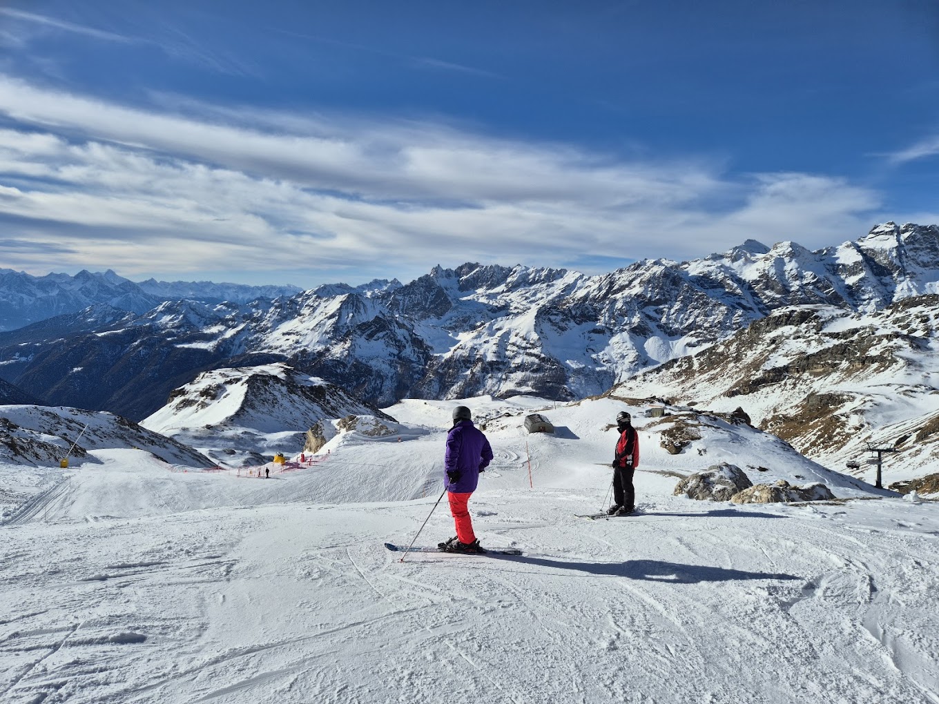 Cervinia Cielo Alto in Italy - a group of people skiing down a snowy slope.
