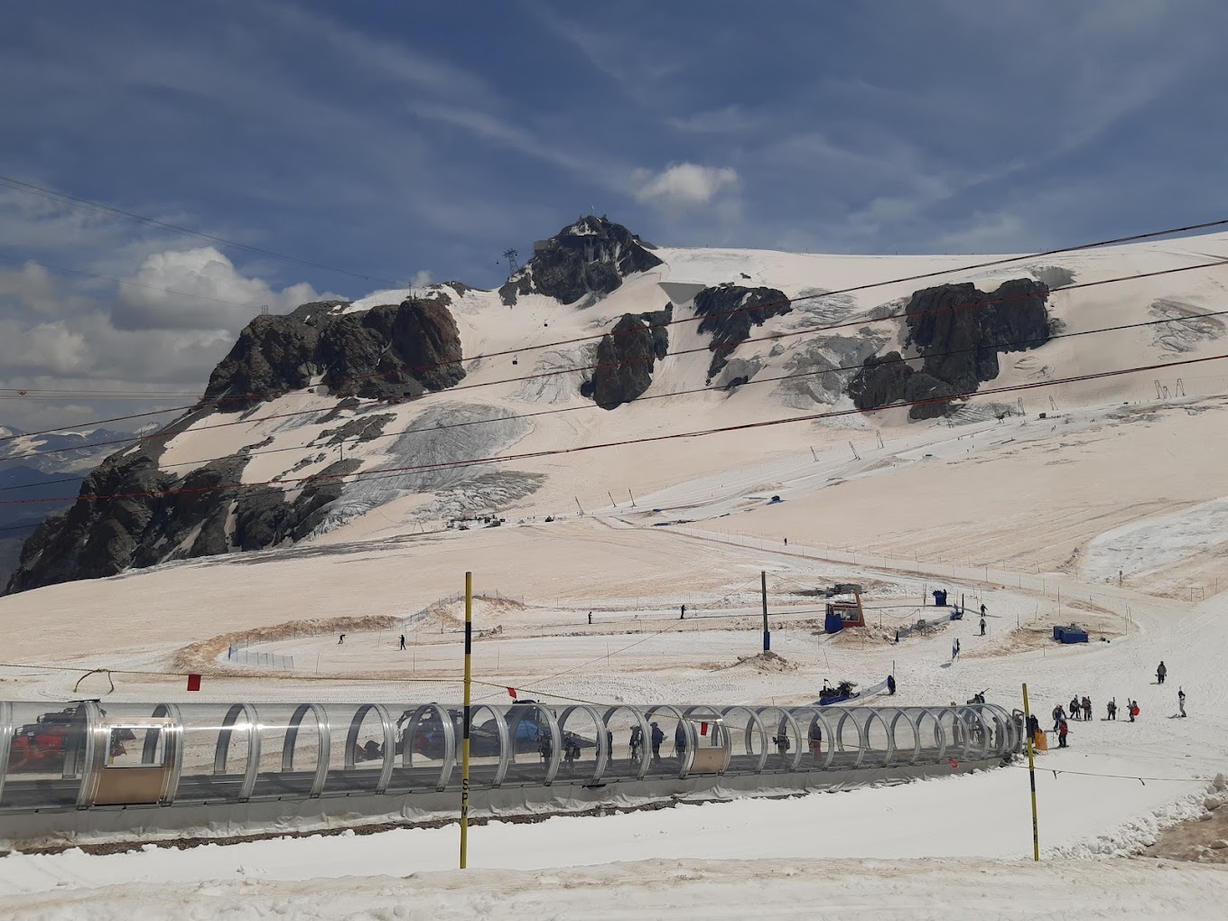 Cervinia Cielo Alto in Italy - a group of people walking down a snow covered slope.