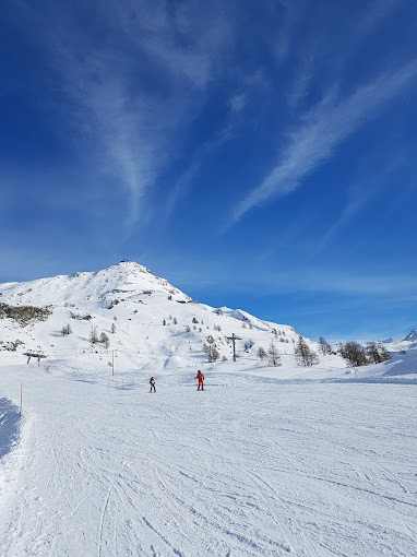 Wolli Park Sunnegga in Switzerland - a person skiing down a snow covered mountain.