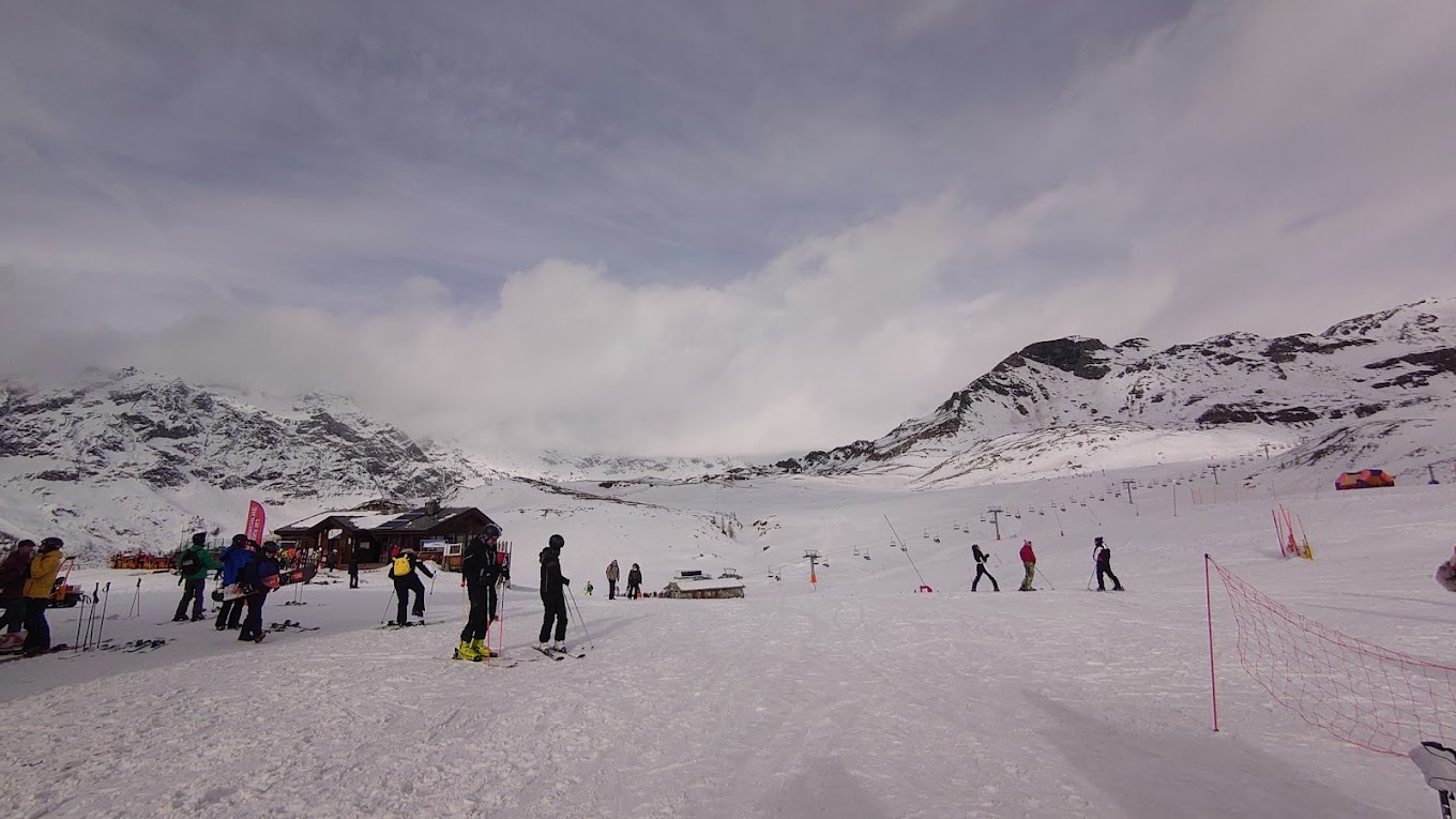 Cime Bianche Funivie Valtournenche in Italy - a group of people standing on a snow covered slope.