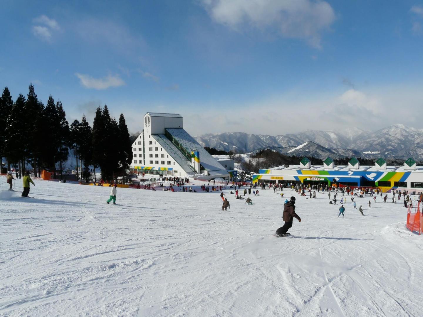 Washigatake Ski in Japan - a group of people skiing down a snowy slope.